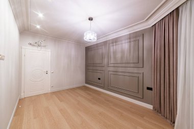 Kahverengi ve beyaz duvarlı ve ahşap zeminli yenilenmeden sonra yeni temiz oda