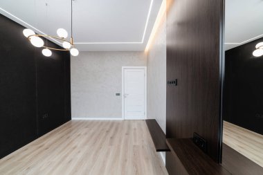 Büyük, temiz bir oda, yeni bir evde karanlık bir duvar.