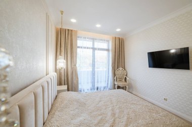 Geniş pencereli ve yataklı bir odanın modern iç tasarımı