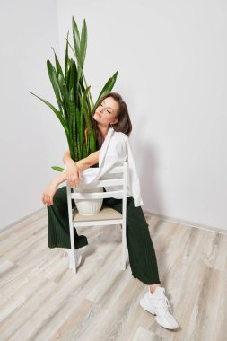 young girl with closed eyes in stylish clothes on the background