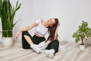photos of a girl model in stylish clothes on the floor