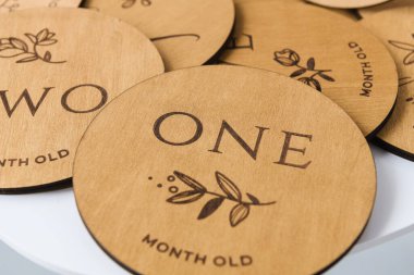 beyaz bir masanın üzerinde yuvarlak ahşap bir yazı var.