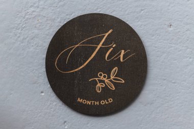 dark wooden round board with the inscription six on a gray background