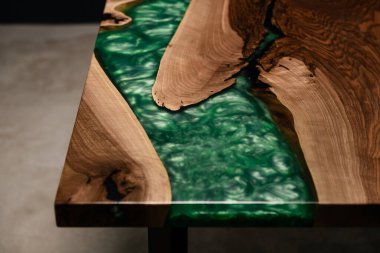 new table made of natural wood and green epoxy resin clipart