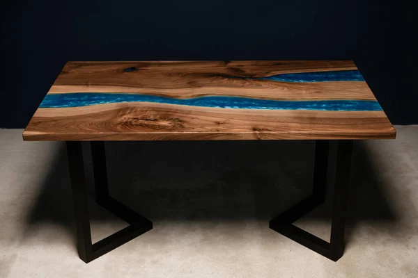 interior item. large table made of natural wood on metal legs