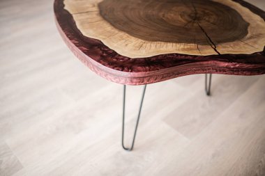 Masa doğal ahşap ve bordo epoksi reçinesinden yapılmıştır.