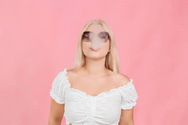 Young Fair Haired Girl Glasses Exhales Smoke Pink Background — Photo