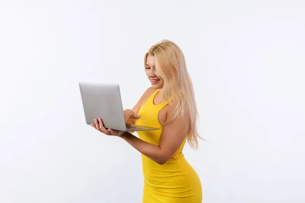 Young Girl Yellow Dress Laptop Her Hands Poses White Background — Zdjęcie stockowe