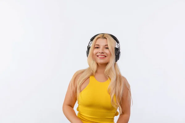 Beautiful Girl Black Headphones Yellow Dress Listens Music White Background — Stok fotoğraf