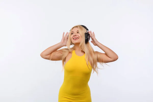 Beautiful Girl Black Headphones Yellow Dress Listens Music White Background — Stok fotoğraf