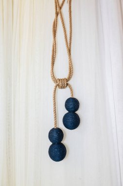 Holders of tulle and curtains in the interior of the house