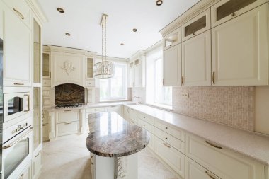 interior design of a modern and stylish bright kitchen in the house