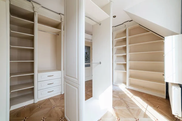 wardrobe room with light furniture, many shelves and places for things