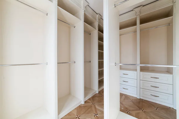 wardrobe room with light furniture, many shelves and places for things