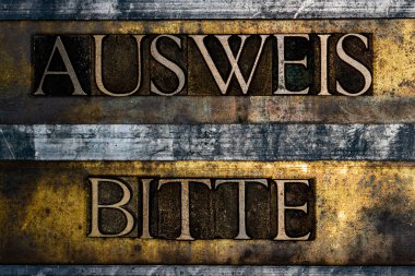 Ausweis Bitte text on textured grunge copper and vintage gold background clipart