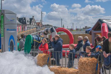 Sint Niklaas, Belgium, May 05, 2019, A photographer is waiting for the right moment to shoot at a soap box race