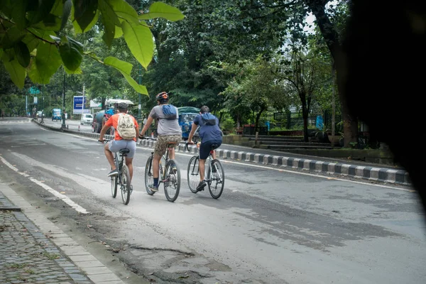29th august 2020. Dehradun, Uttarakhand, India. a group of cyclist with backpack riding in the wet empty streets of dehradun city of India in the morning.