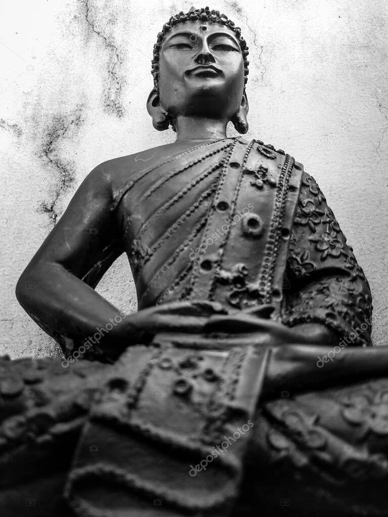 June 3rd 2021. dehradun Uttarakhand India. Buddha Purnima. An old Budha Statue sitting in lotus Pose with a vintage white background.