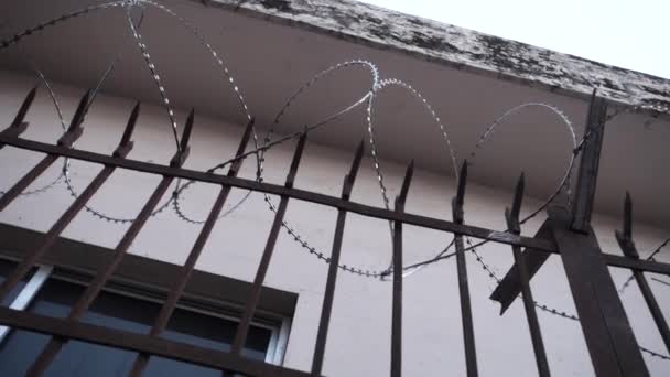 金属グリル付きの建物の外の有刺鉄線エンクロージャ — ストック動画