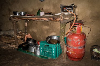 July 7th 2021 Uttarakhand India. Traditional kitchen made of mud and clay in rural Household with fuel tank and kitchenware.