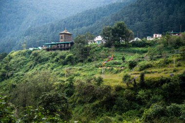 Uttarakhand India. A small ancient temple on a hill top surround with deodar forest.