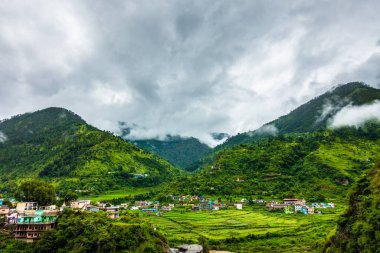 A wide angle shot of a village in the mountains of Lower Himalayan region of Uttarakhand State, India.