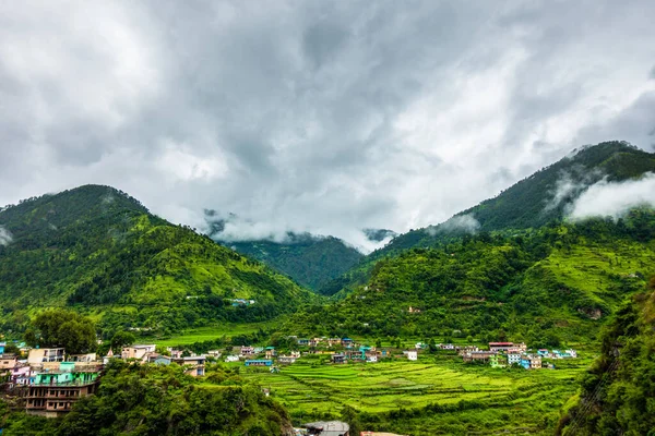 A wide angle shot of a village in the mountains of Lower Himalayan region of Uttarakhand State, India.