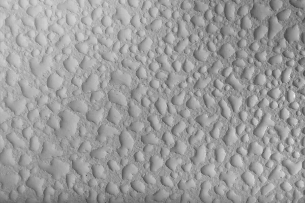 Water droplets on a white and grey background, Textured Wall. India.