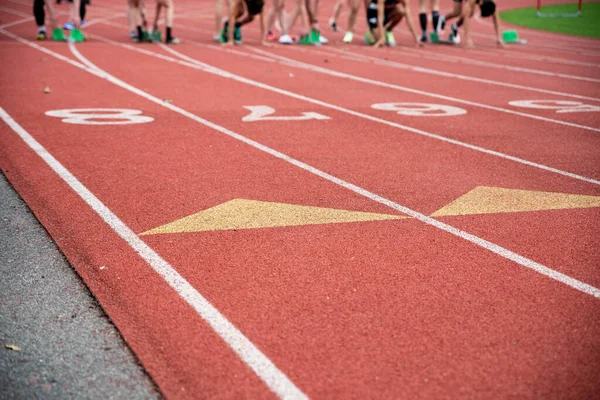 Runners at the starting blocks on an athletic racing track