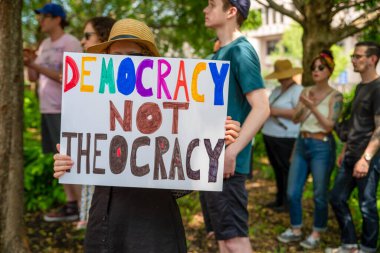 Bitkileri ve sıra örtüleri olan organik sebze serası açık kapıdan görülebiliyor. Mavi gökyüzü ve yeşil çimenler, insan yok, kopyalama alanı var..