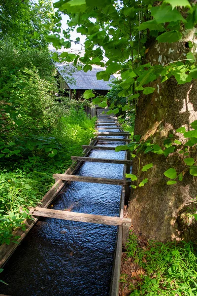 Wooden Colonial American Sluice Leads Away Camera Next Large Tree — Photo