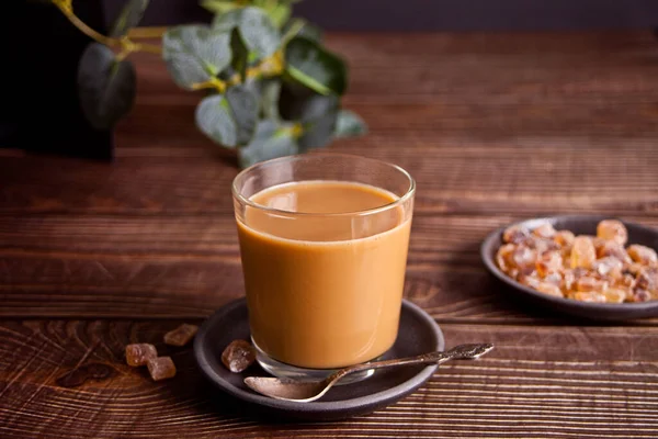 Copo de café leitoso com açúcar doce de rocha. — Fotografia de Stock