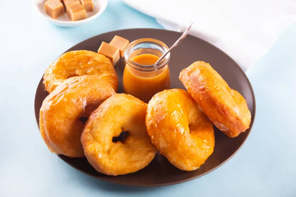 Homemade delicious donuts with caramel syrup sauce on the plate — Stock Photo, Image