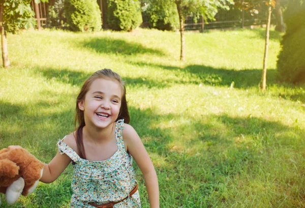 Happy smiling little girl playing with toy in the kindergarden i — Stock Photo, Image