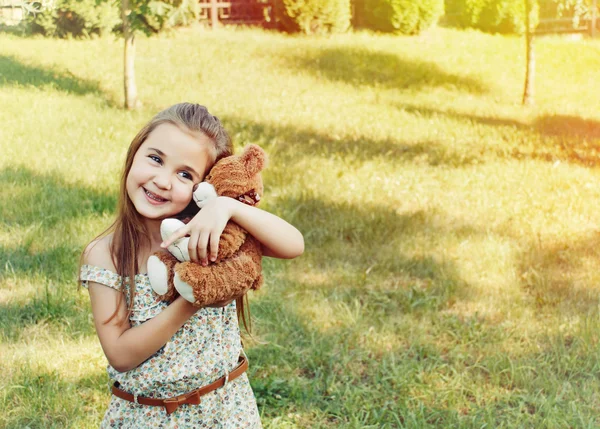 Happy smiling little girl playing with toy in the kindergarden i — Stock Photo, Image