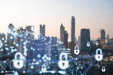 Güneydoğu Asya, Bangkok 'un günbatımı panoramik şehir manzarasında Padlock' un hologramı. Siber güvenlik istihbaratı kavramı. Çoklu pozlama.