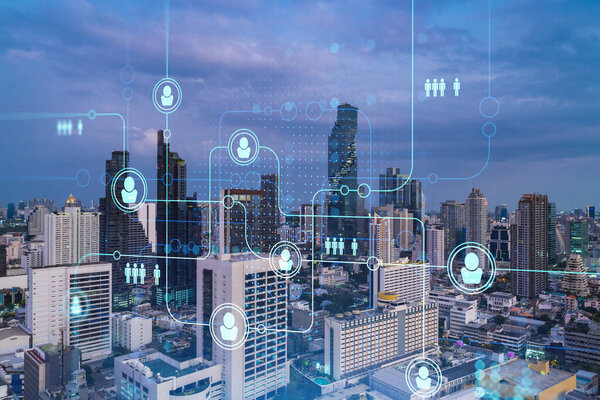 Hologram of social media icons over sunset panoramic cityscape of Bangkok, Southeast Asia. The concept of people connections and career opportunities. Multi exposure.