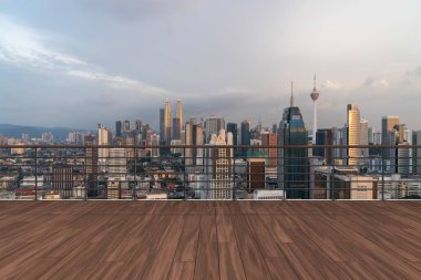 Panoramik Kuala Lumpur gökyüzü manzarası, çatıda ahşap gözlemevi güvertesi, günbatımı. Asyalı şirket ve yaşam tarzı. Şehir merkezinde finans şehri, gayrimenkul. Ürün ekran modeli boş çatı