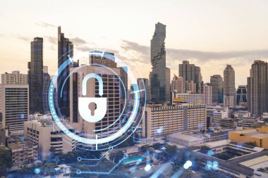 Güneydoğu Asya, Bangkok 'un günbatımı panoramik şehir manzarasında Padlock' un hologramı. Siber güvenlik istihbaratı kavramı. Çoklu pozlama.