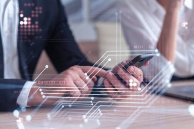 İki araştırma ve geliştirme uzmanı, iş dünyasını geliştirmek için yazılım geliştirmek amacıyla yeni bir yaklaşım geliştirmek amacıyla proje üzerinde beyin fırtınası yapıyorlar. Telefonla çalışıyorum. Teknik hologram simgeleri. Resmi giysi.