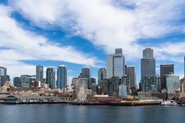 Seattle ufuk çizgisi, rıhtım ve harika tekerlek manzaralı. Gündüz vakti Washington, ABD 'de finans merkezinin gökdelenleri. Parlak bir iş çevresi.