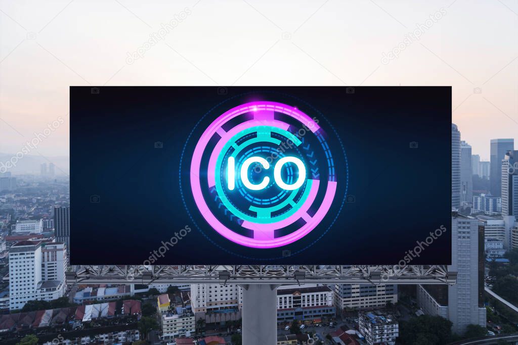 ICO hologram icon on billboard over panorama city view of Kuala Lumpur at sunset. KL is the hub of blockchain projects in Malaysia, Asia. The concept of initial coin offering, decentralized finance