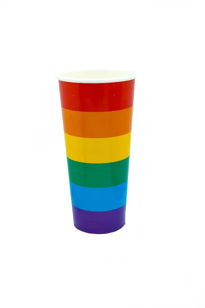 Paper cup painted as a rainbow on a white background. Coloring LGBT symbol concept or celebratory drink in cafe. Isolate Copy space — Stock Photo, Image