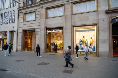  BARCELONA, İspanya - 10 Mart 2022: Barcelona 'daki Stradivarius mağazasından alışveriş yapan turistler
