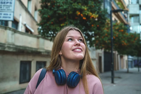 Jeune femme rêveuse regardant dans la rue — Photo