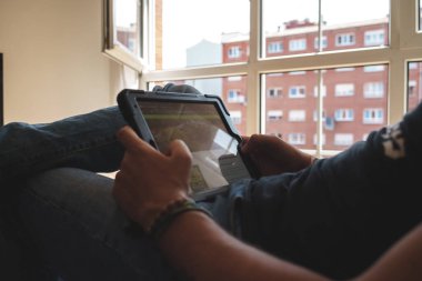 man looking at the tablet at home. High quality photo