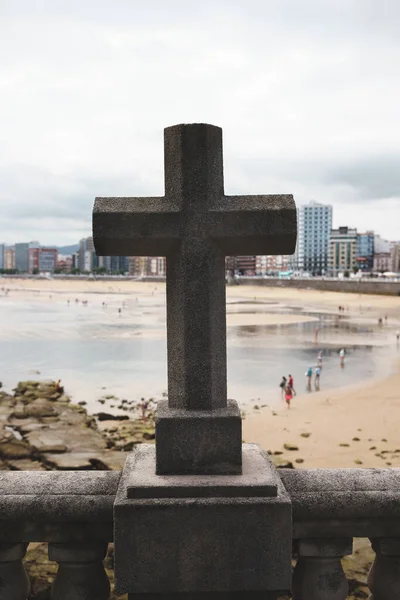 stone religious cross in front of the beach. High quality photo