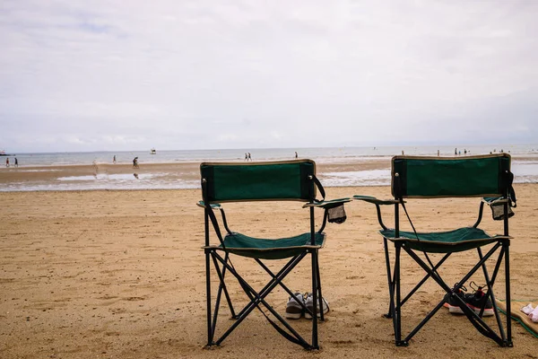 two beach chairs without people on the beach. High quality photo