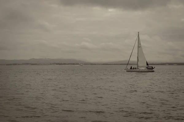 black and white image of a boat sailing on the Tejo River in Lisbon