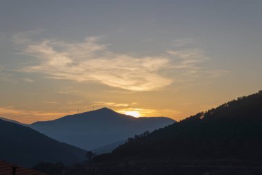 Gün batımında dağ resmi Bulutlu bir gökyüzü